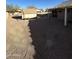Large backyard featuring gravel landscaping, a shed, and a covered patio, ideal for entertaining and relaxing at 15659 W Ripple Cir, Goodyear, AZ 85338