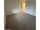 Neutral bedroom featuring plush carpeting and closet at 15659 W Ripple Cir, Goodyear, AZ 85338