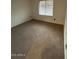 Carpeted bedroom featuring a window and neutral paint at 15659 W Ripple Cir, Goodyear, AZ 85338