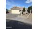 Charming single-story home with a well-maintained front yard and a two-car garage at 15659 W Ripple Cir, Goodyear, AZ 85338