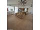 Bright living room with a large ceiling fan and an island with a built-in wine rack at 15659 W Ripple Cir, Goodyear, AZ 85338