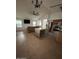 Bright living room with a large ceiling fan and an island with a built-in wine rack at 15659 W Ripple Cir, Goodyear, AZ 85338