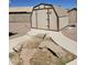 View of shed and concrete pathway in gravel backyard at 15659 W Ripple Cir, Goodyear, AZ 85338