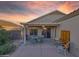 This lovely back patio has a serene setting with a table and four chairs at 15848 W Lahlum Ln, Surprise, AZ 85374