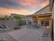 Inviting back patio features comfortable seating and relaxing sunset views at 15848 W Lahlum Ln, Surprise, AZ 85374