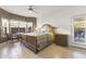 This airy bedroom offers neutral paint, ceiling fan, backyard access, and an elegant window and dresser at 15848 W Lahlum Ln, Surprise, AZ 85374