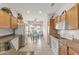 Bright kitchen featuring neutral countertops, white appliances, and a breakfast bar with a view to the backyard at 15848 W Lahlum Ln, Surprise, AZ 85374