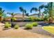 Exterior view of the house with a lush backyard landscaping at 16026 N 171St Ln, Surprise, AZ 85388