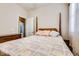 Bedroom featuring a four-poster bed and a view into an adjacent bathroom at 16026 N 171St Ln, Surprise, AZ 85388