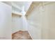 Walk-in closet with tiled floor and built-in shelving for organized storage at 16026 N 171St Ln, Surprise, AZ 85388