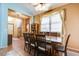 Traditional dining room featuring a wood table, elegant curtains, and tiled floor at 16026 N 171St Ln, Surprise, AZ 85388