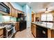 Well-equipped kitchen featuring stainless steel appliances, granite countertops, and tiled flooring at 16026 N 171St Ln, Surprise, AZ 85388