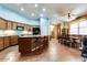 Open kitchen with a large island, wood cabinets, and stainless steel appliances, flowing into the dining area at 16026 N 171St Ln, Surprise, AZ 85388
