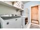 Laundry room equipped with Maytag washer and dryer and shelving at 16026 N 171St Ln, Surprise, AZ 85388