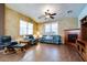 Spacious living room featuring a fireplace, comfortable seating, and lots of natural light from two windows at 16026 N 171St Ln, Surprise, AZ 85388