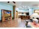 Cozy living room area featuring tile flooring and a large entertainment center, open to the kitchen at 16026 N 171St Ln, Surprise, AZ 85388