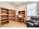 Office setup with a desk, ample shelving, and a comfortable leather chair for a productive workspace at 16026 N 171St Ln, Surprise, AZ 85388