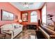Home office space with warm colors, a sofa, a piano, and a window for natural light at 16026 N 171St Ln, Surprise, AZ 85388