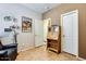 Bright office space with unique wall art, a secretary desk, and dual doors for flexible access at 16026 N 171St Ln, Surprise, AZ 85388