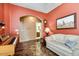 Office featuring a light-colored wall, an arched doorway to an adjacent bathroom, a piano, and a sofa at 16026 N 171St Ln, Surprise, AZ 85388