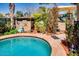Beautiful backyard pool with charming landscaping, garden decor, and relaxing atmosphere at 16026 N 171St Ln, Surprise, AZ 85388