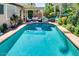 Backyard pool surrounded by lush landscaping and an outdoor seating area at 16026 N 171St Ln, Surprise, AZ 85388