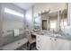 The bathroom features a granite countertop vanity, natural lighting, and a walk-in shower at 16137 W Quail Creek Ln, Surprise, AZ 85374