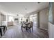 Open-concept dining area connected to the living room and featuring a sliding glass door at 16137 W Quail Creek Ln, Surprise, AZ 85374