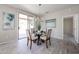 Cozy dining area with a modern chandelier, artwork, and a sliding door to the patio at 16137 W Quail Creek Ln, Surprise, AZ 85374