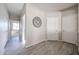 Hallway view with wood-style flooring, leading to other rooms with white doors at 16137 W Quail Creek Ln, Surprise, AZ 85374