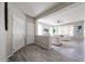 Open-concept living room with wood-style flooring, neutral colors, and natural light at 16137 W Quail Creek Ln, Surprise, AZ 85374