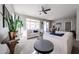 Bright and airy living room featuring neutral tones, a ceiling fan, and ample natural light at 16137 W Quail Creek Ln, Surprise, AZ 85374