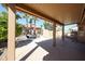 Covered patio with an outdoor grill, seating area, and desert landscaping, perfect for outdoor entertaining at 16137 W Quail Creek Ln, Surprise, AZ 85374