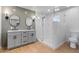 A modern bathroom featuring a double vanity and luxurious glass shower at 1642 E Turney Ave, Phoenix, AZ 85016