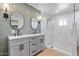 A beautifully renovated bathroom with a dual sink vanity and a glass-enclosed shower at 1642 E Turney Ave, Phoenix, AZ 85016