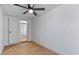 Bedroom with hardwood floors, ceiling fan, and a view through an open door at 1642 E Turney Ave, Phoenix, AZ 85016