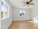 Bedroom featuring wood floors, white walls and ceilings, modern lighting, and two sunny windows at 1642 E Turney Ave, Phoenix, AZ 85016