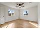 Bright bedroom featuring wood floors, white walls and ceilings, modern lighting, and two sunny windows at 1642 E Turney Ave, Phoenix, AZ 85016