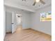 Bedroom with hardwood floors, ceiling fan, and a window looking out to the backyard at 1642 E Turney Ave, Phoenix, AZ 85016