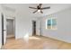 Bedroom with wood floors, white walls and ceilings, modern lighting, closet and sunny window at 1642 E Turney Ave, Phoenix, AZ 85016