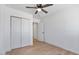 Cozy bedroom features ceiling fan, closet with sliding doors, and hardwood flooring at 1642 E Turney Ave, Phoenix, AZ 85016