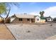Charming single-story home featuring xeriscaping, a wooden fence, and covered porch at 1642 E Turney Ave, Phoenix, AZ 85016