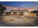 Charming single-story home featuring xeriscaping, a tile walkway and covered porch at 1642 E Turney Ave, Phoenix, AZ 85016