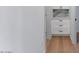 Hallway area features white cabinets with black hardware and hardwood flooring at 1642 E Turney Ave, Phoenix, AZ 85016