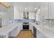 This kitchen features stone countertops, white cabinets, and a stainless steel gas range at 1642 E Turney Ave, Phoenix, AZ 85016