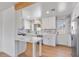 This kitchen features white cabinets, stone countertops, and stainless steel appliances at 1642 E Turney Ave, Phoenix, AZ 85016
