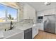This kitchen features white cabinets, stone countertops, and stainless steel appliances at 1642 E Turney Ave, Phoenix, AZ 85016