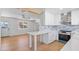 This kitchen features an eat-in counter, stainless steel appliances, and views to the breakfast area at 1642 E Turney Ave, Phoenix, AZ 85016