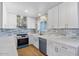 This kitchen features white cabinets, stone countertops, and stainless steel appliances at 1642 E Turney Ave, Phoenix, AZ 85016