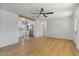 Bright open living room featuring wood floors, modern lighting, and a view into the kitchen at 1642 E Turney Ave, Phoenix, AZ 85016